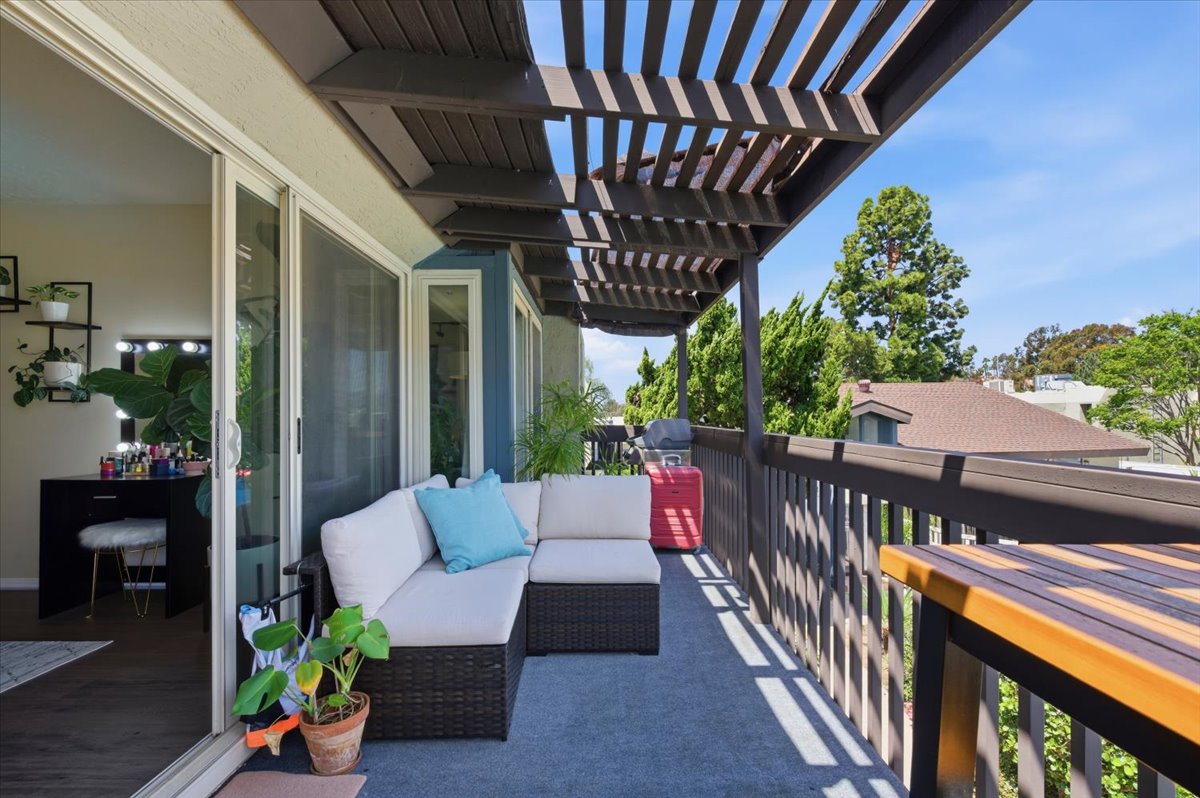 6373 Rancho Mission Road, Unit 5 San Diego, CA 92108 - Photo 6 of 30 a view of a porch with furniture and wooden floor