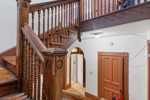 a view of a hallway and a livingroom with furniture