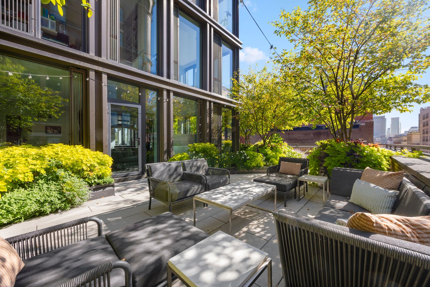 a view of a patio with couches table and chairs and potted plants