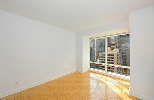 845 United Nations Plaza, Unit 56E Manhattan, NY 10017 - Photo 3 of 28 a view of an empty room with a window