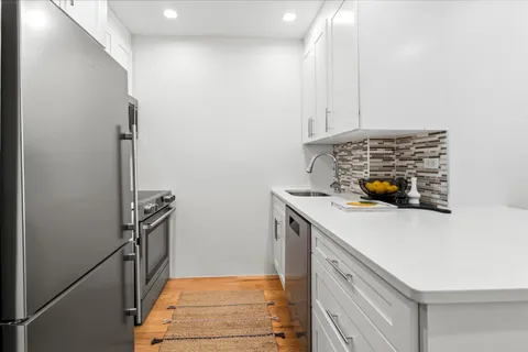 a kitchen with a sink and a stove top oven
