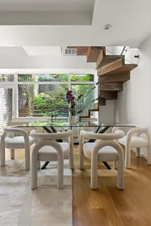a living room with patio furniture and a floor to ceiling window