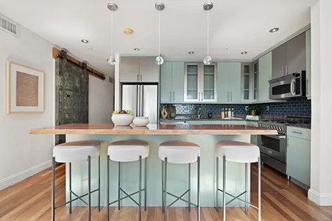 a kitchen with stainless steel appliances granite countertop a sink and a white cabinets
