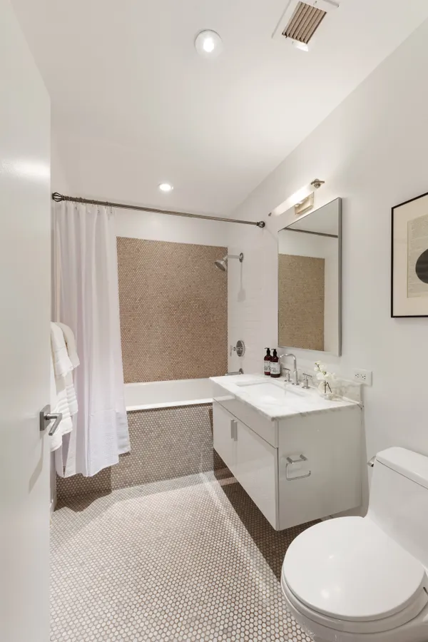 a bathroom with a sink a toilet and mirror