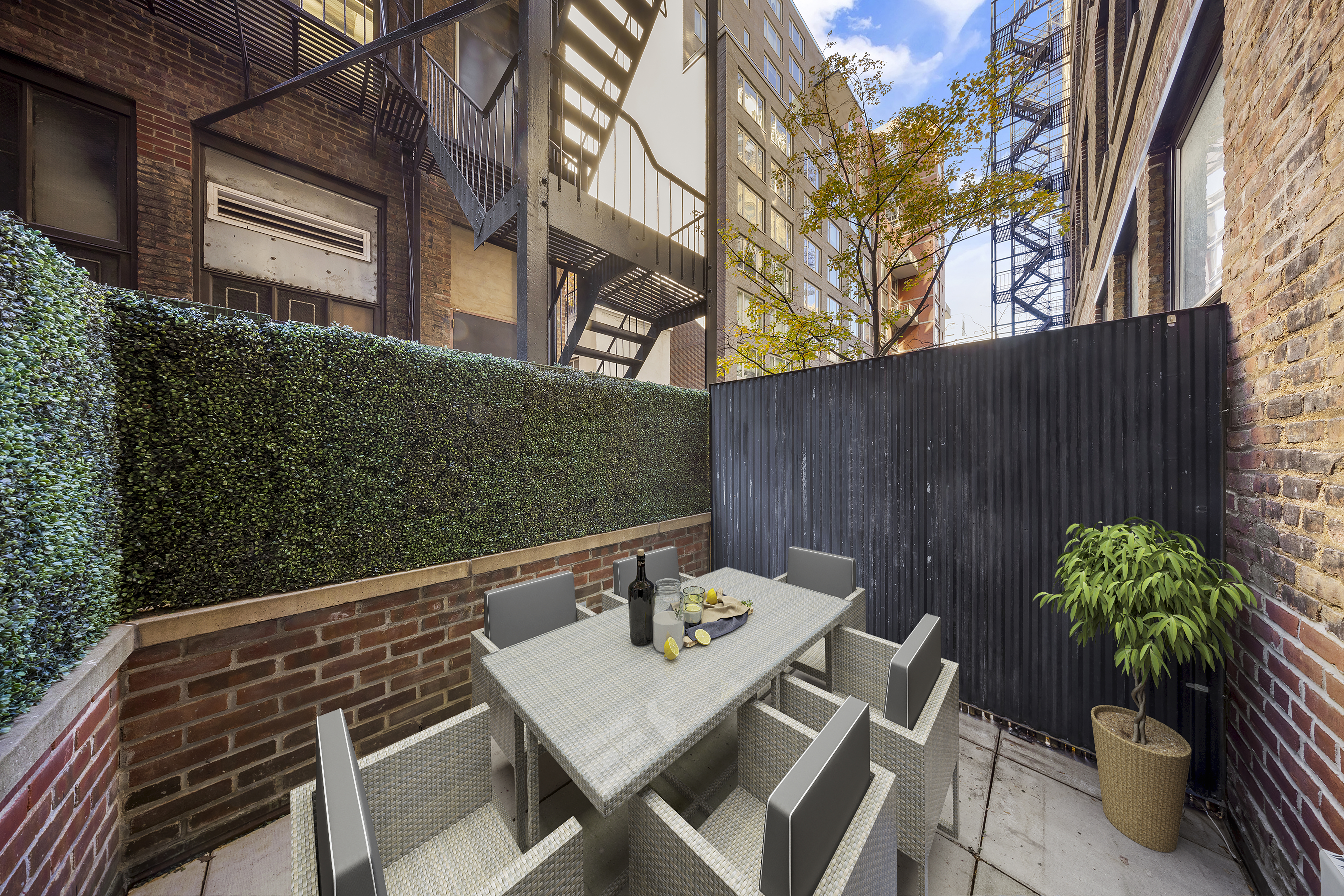 140 West 22nd Street, Unit 2D Manhattan, NY 10011 - Photo 1 of 11 a backyard of a house with table and chairs
