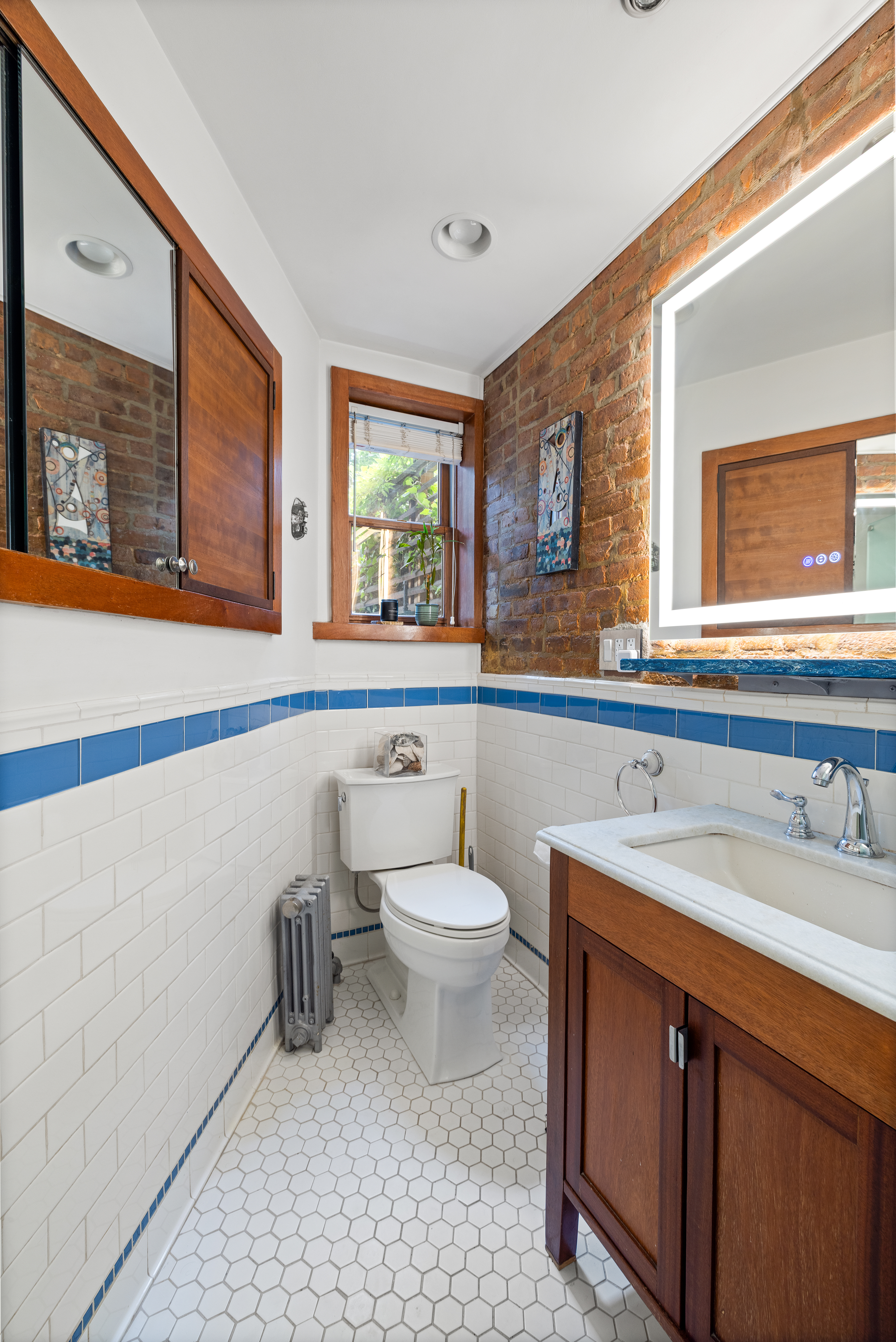 445 Greene Avenue, Unit 1 Brooklyn, NY 11216 - Photo 7 of 12 a bathroom with a sink a toilet and mirror