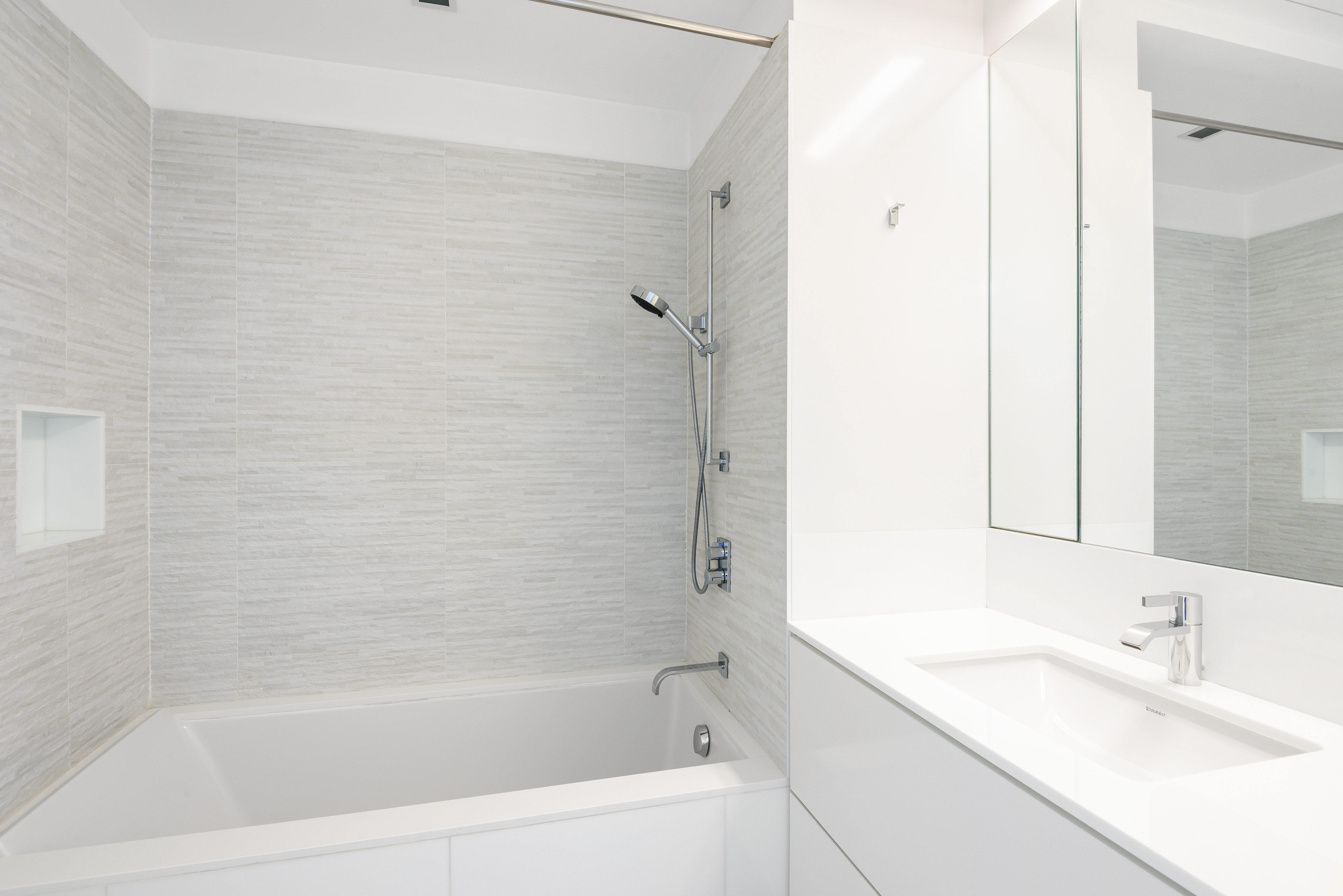 1 Main Street, Unit 9H Brooklyn, NY 11201 - Photo 11 of 15 a white bath tub sitting next to a white sink