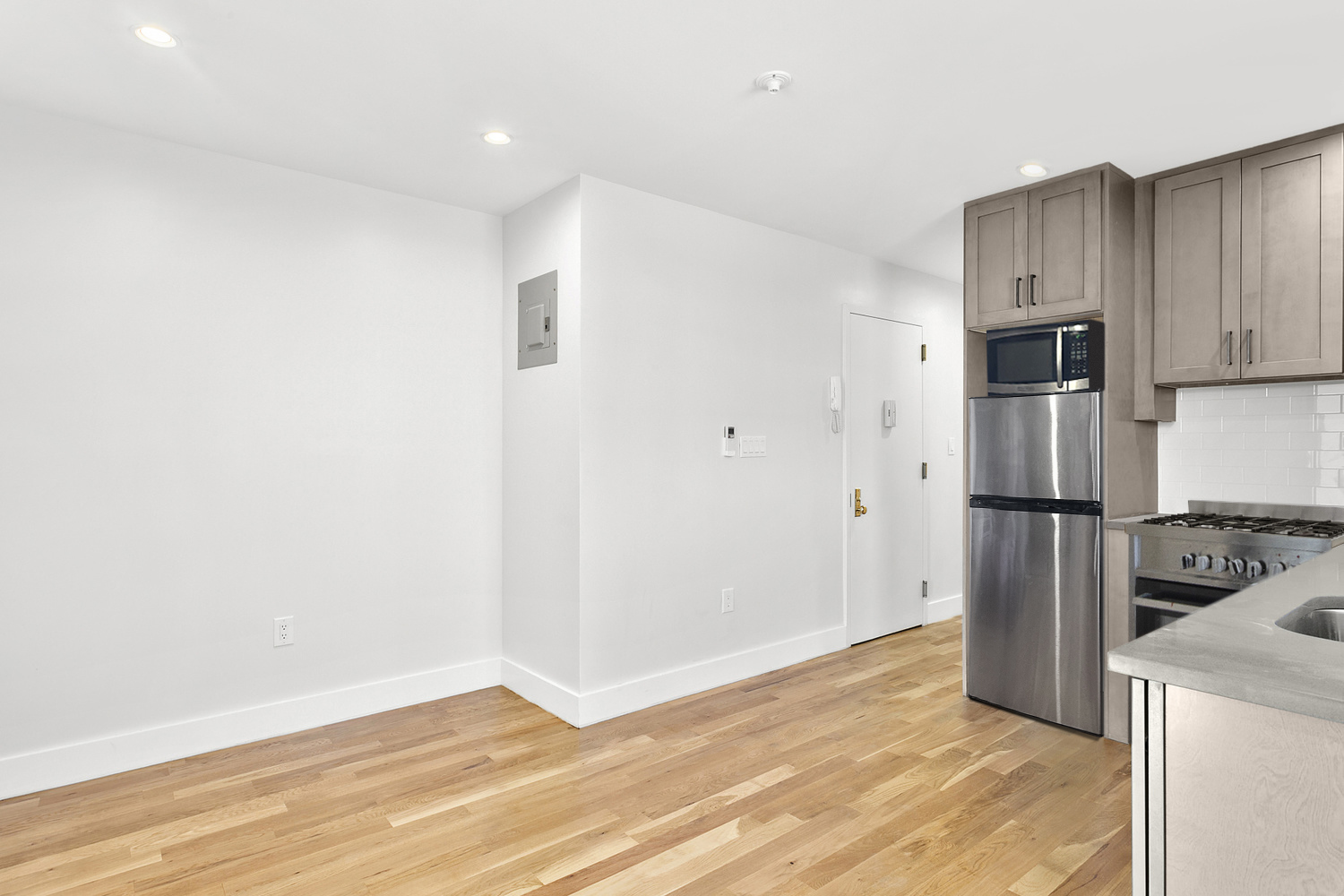 276 3rd Avenue, Unit 4A Brooklyn, NY 11215 - Photo 2 of 6 a view of a kitchen with a refrigerator cabinets and a wooden floor