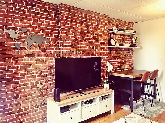 344 East 61st Street, Unit 12 Manhattan, NY 10065 - Photo 3 of 10 a view of a brick wall with chairs