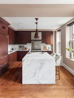 a bedroom with bed and a large window