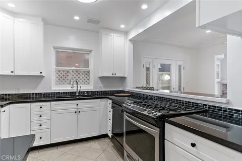 a bathroom with a granite countertop sink a mirror and a shower
