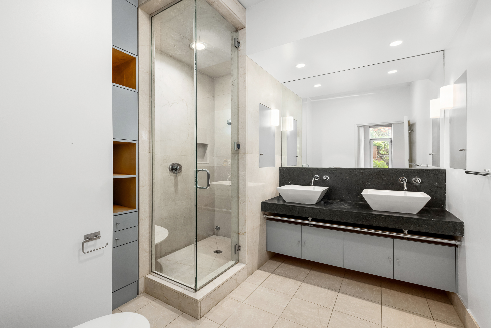 308 East 15th Street, Unit PARLOR Manhattan, NY 10003 - Photo 10 of 16 a large bathroom with a granite countertop sink mirror and shower