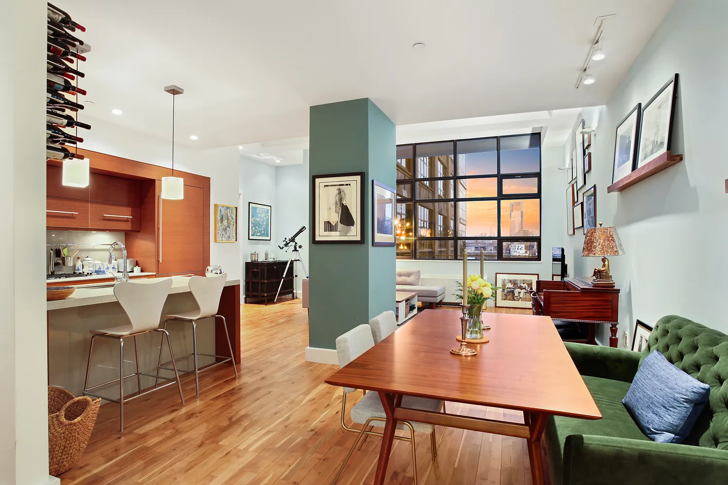 a dinning room with furniture a window and kitchen view