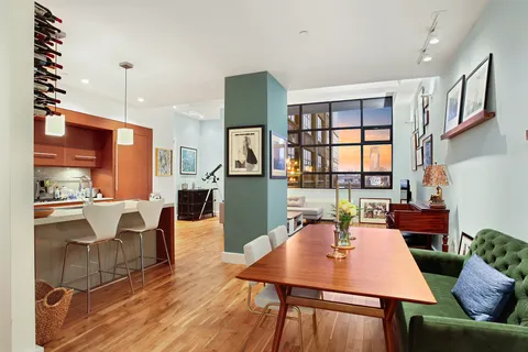 a dinning room with furniture a window and kitchen view