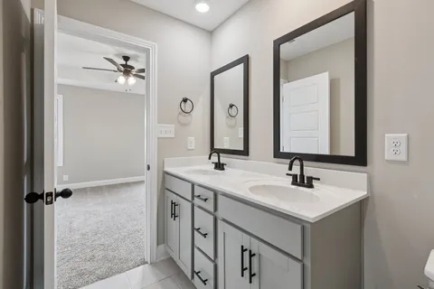 a bathroom with a double vanity sink and mirror