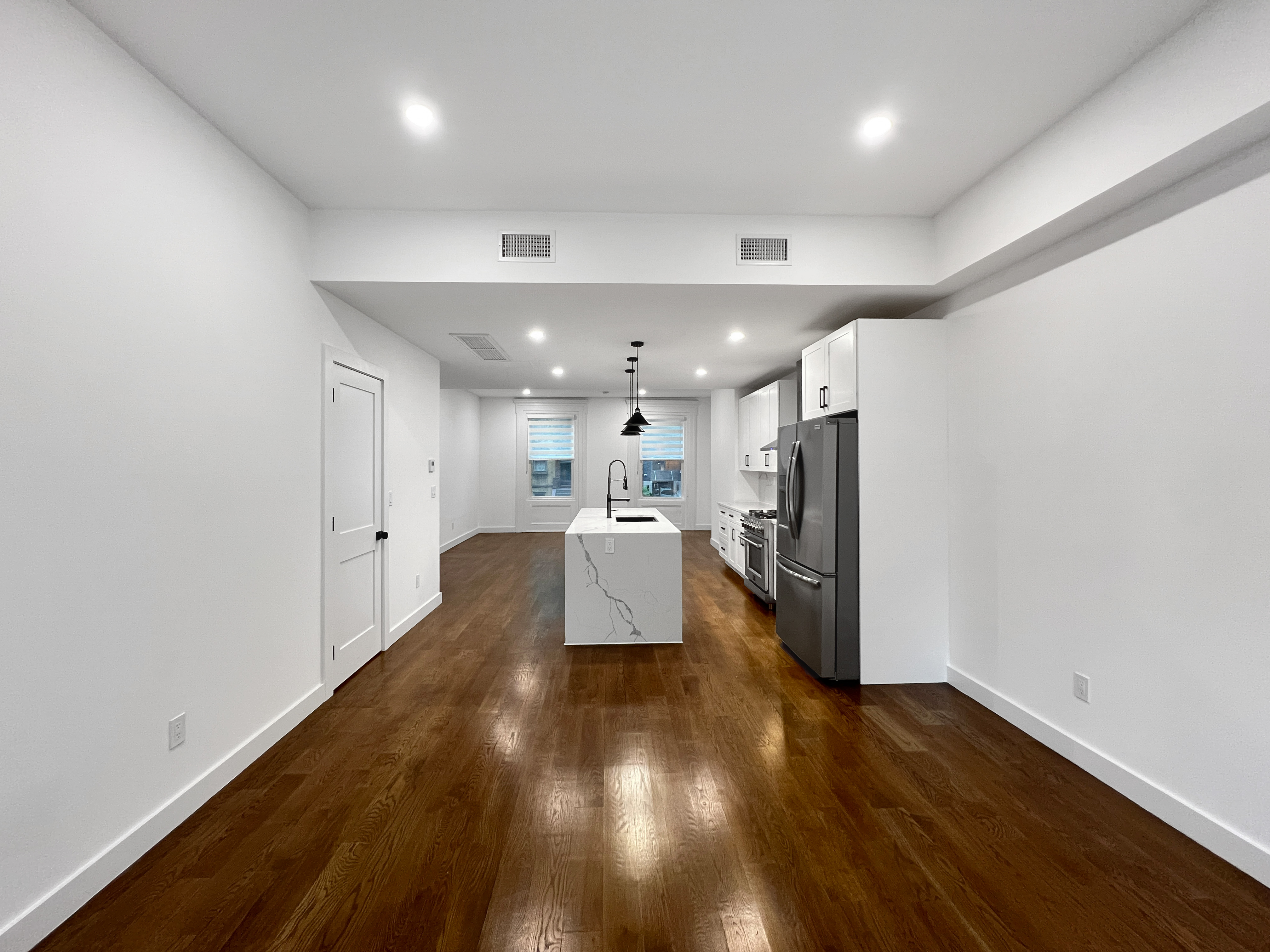 352 Degraw Street, Unit 1 Brooklyn, NY 11231 - Photo 6 of 20 a view of a living room a kitchen with wooden floor and a window