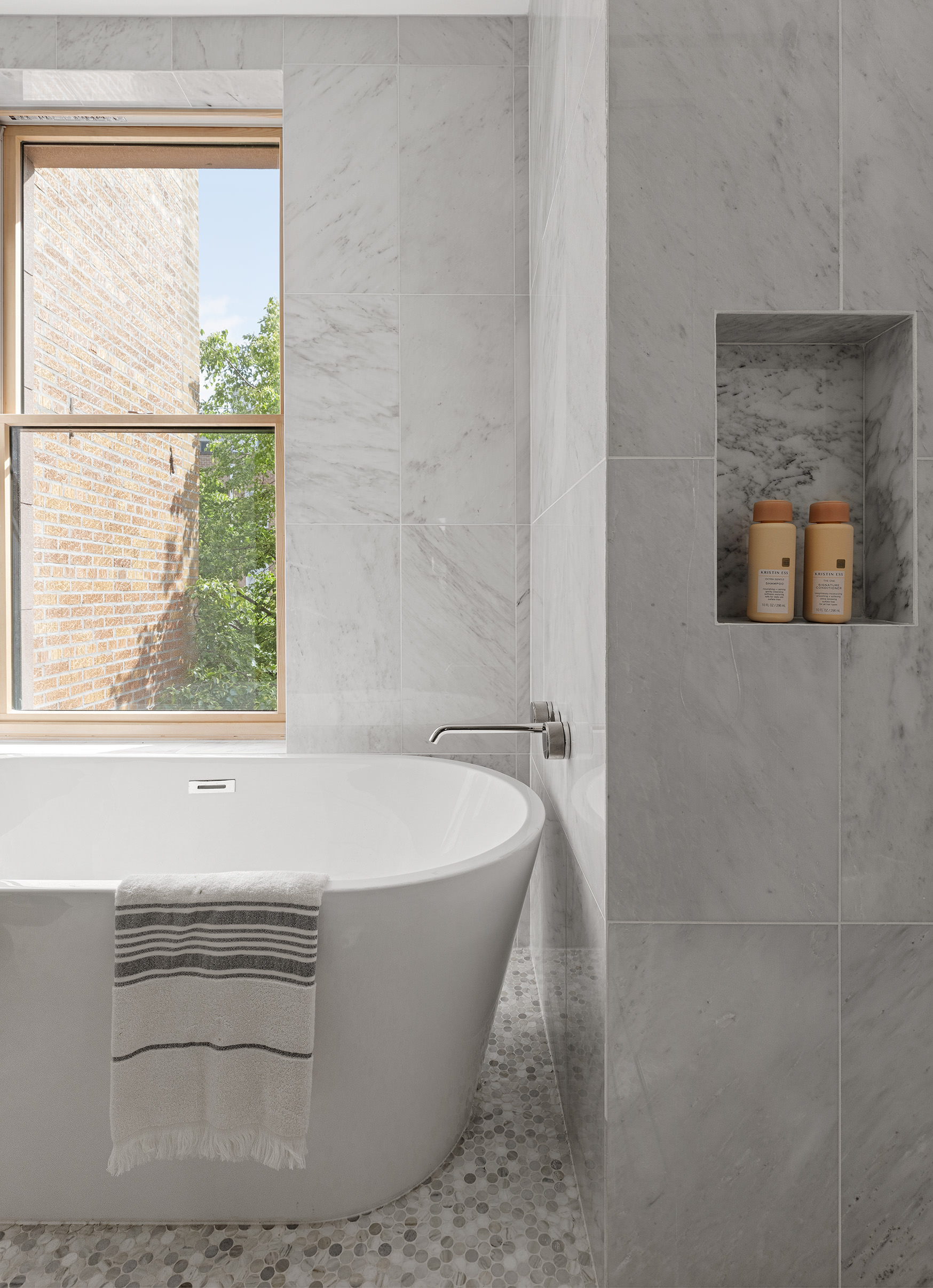 363 Warren Street Brooklyn, NY 11201 - Photo 12 of 23 a white bath tub sitting in a bathroom next to a window