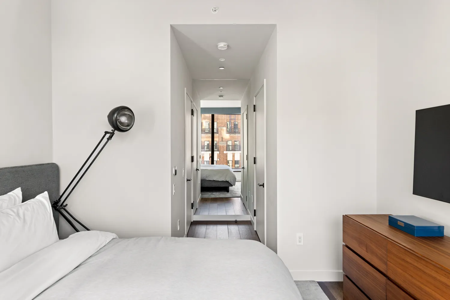 a bedroom with a bed and a mirror