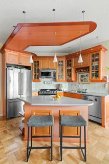 a kitchen with stainless steel appliances granite countertop a stove a sink and a refrigerator