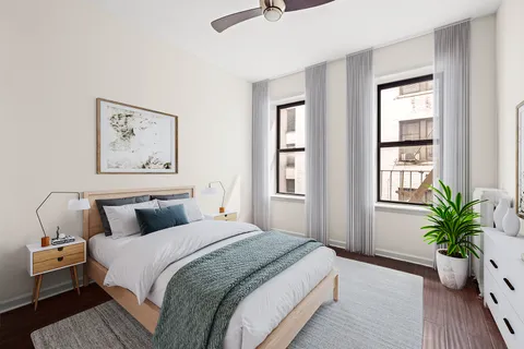 a bedroom with bed and window