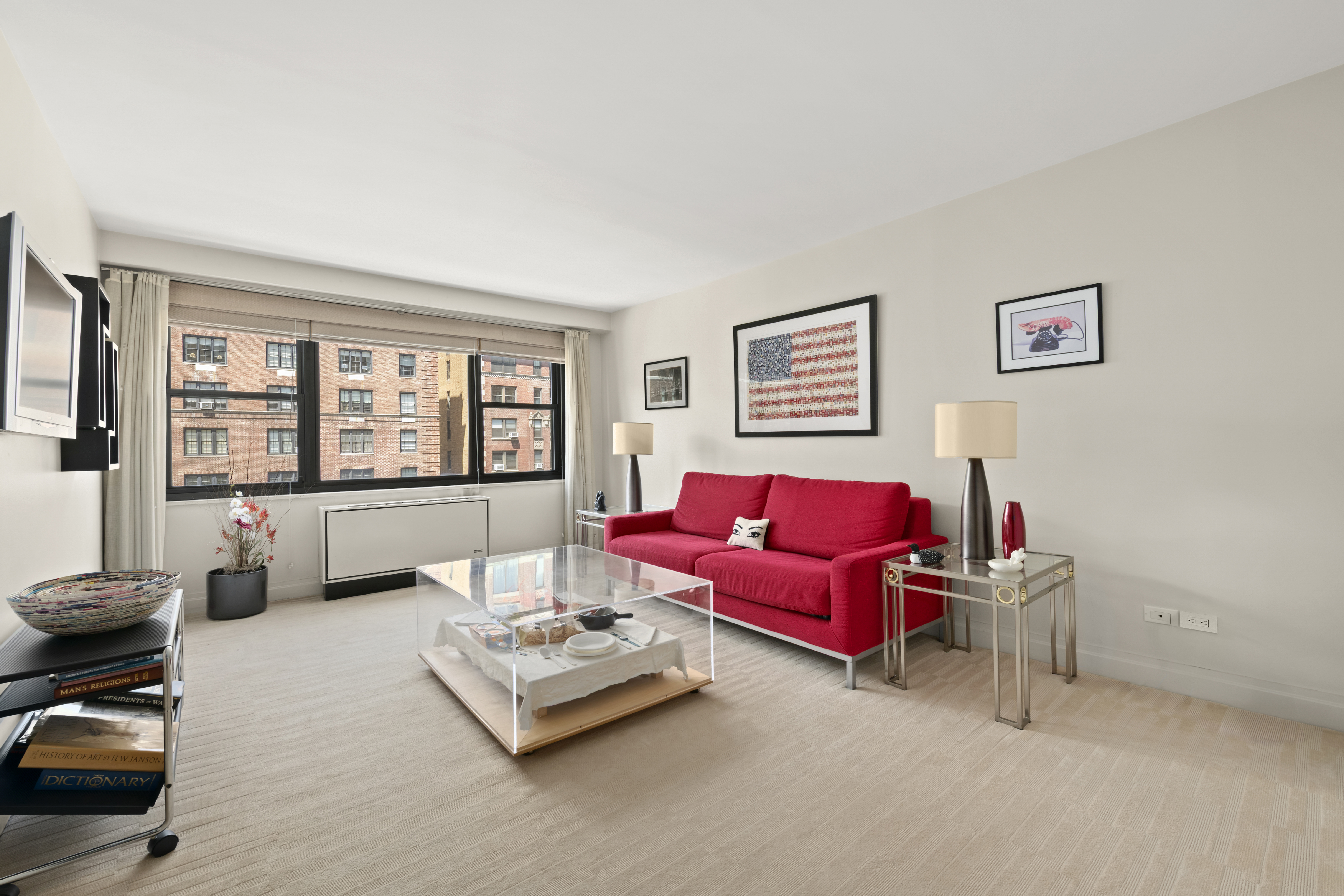 1065 Park Avenue, Unit 11A Manhattan, NY 10128 - Photo 10 of 14 a living room with furniture and a large window