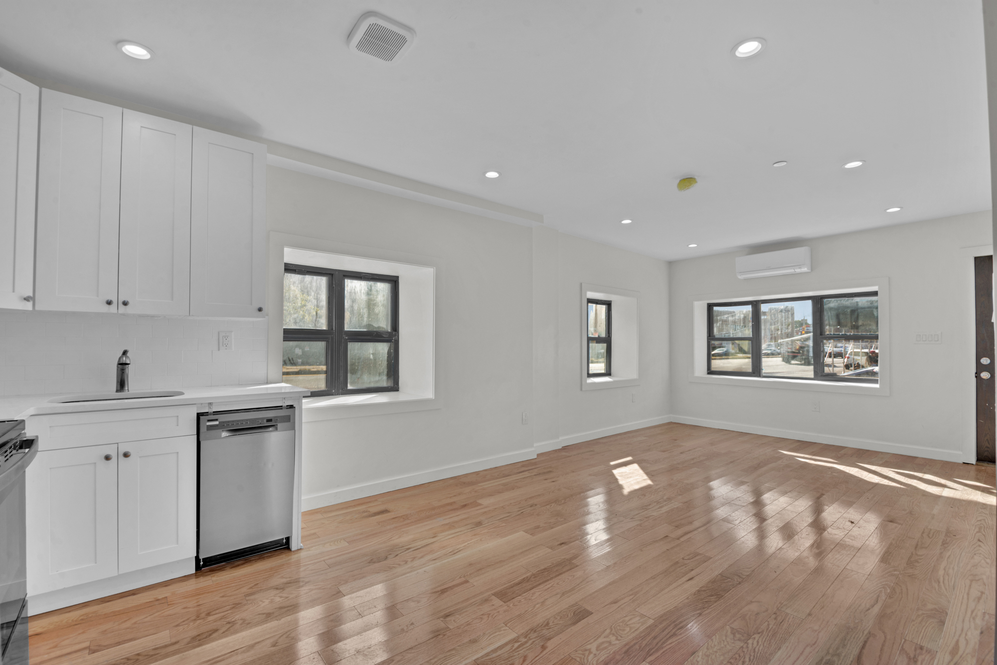 31 Roosevelt Place, Unit 1A Brooklyn, NY 11233 - Photo 3 of 14 a kitchen with granite countertop white cabinets and black appliances