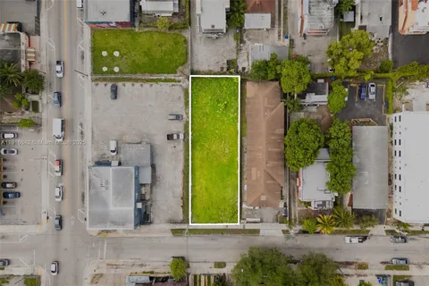 aerial view of a house with a backyard