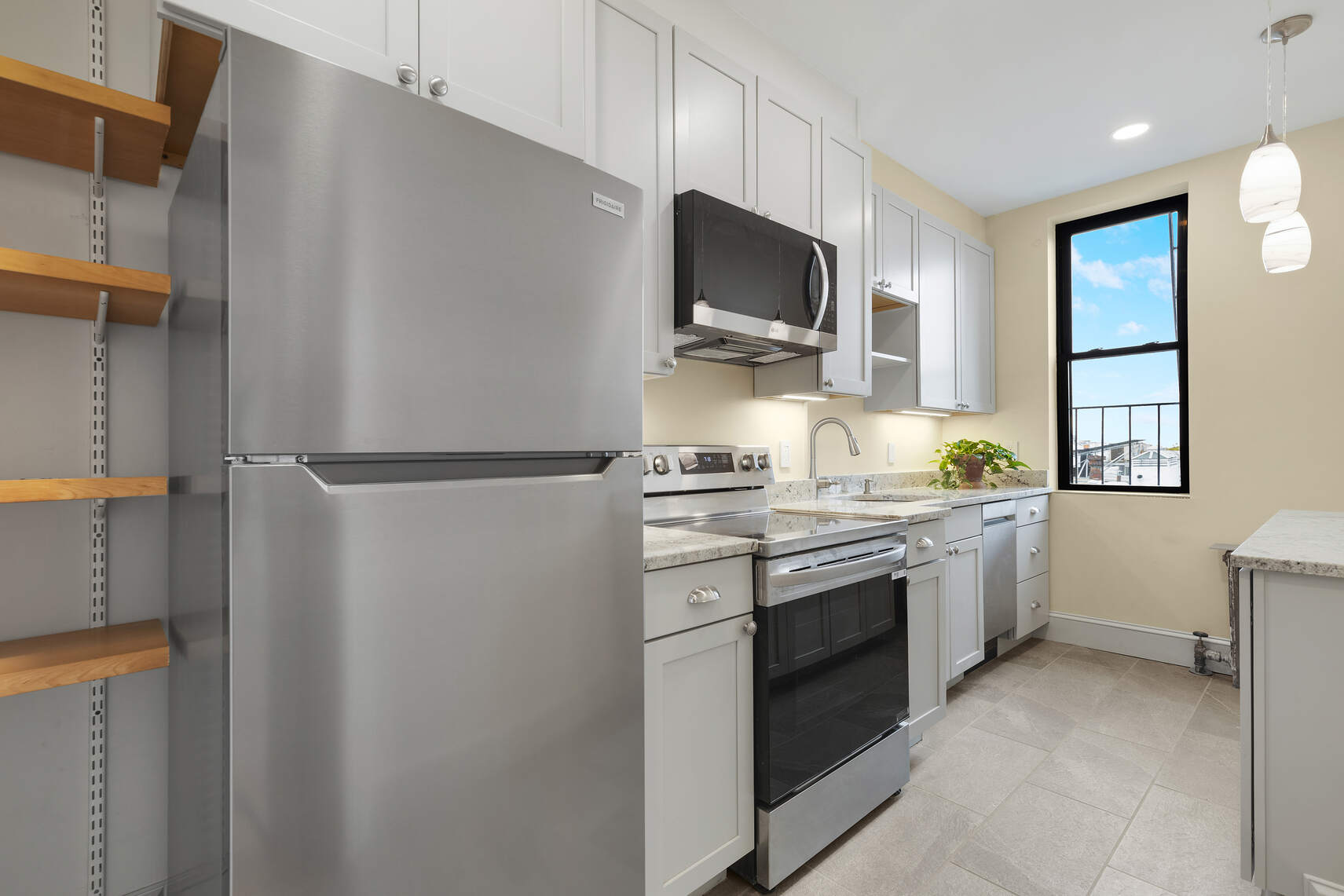 159 Prospect Park West, Unit 4 Brooklyn, NY 11215 - Photo 3 of 14 a kitchen with a sink stove and microwave