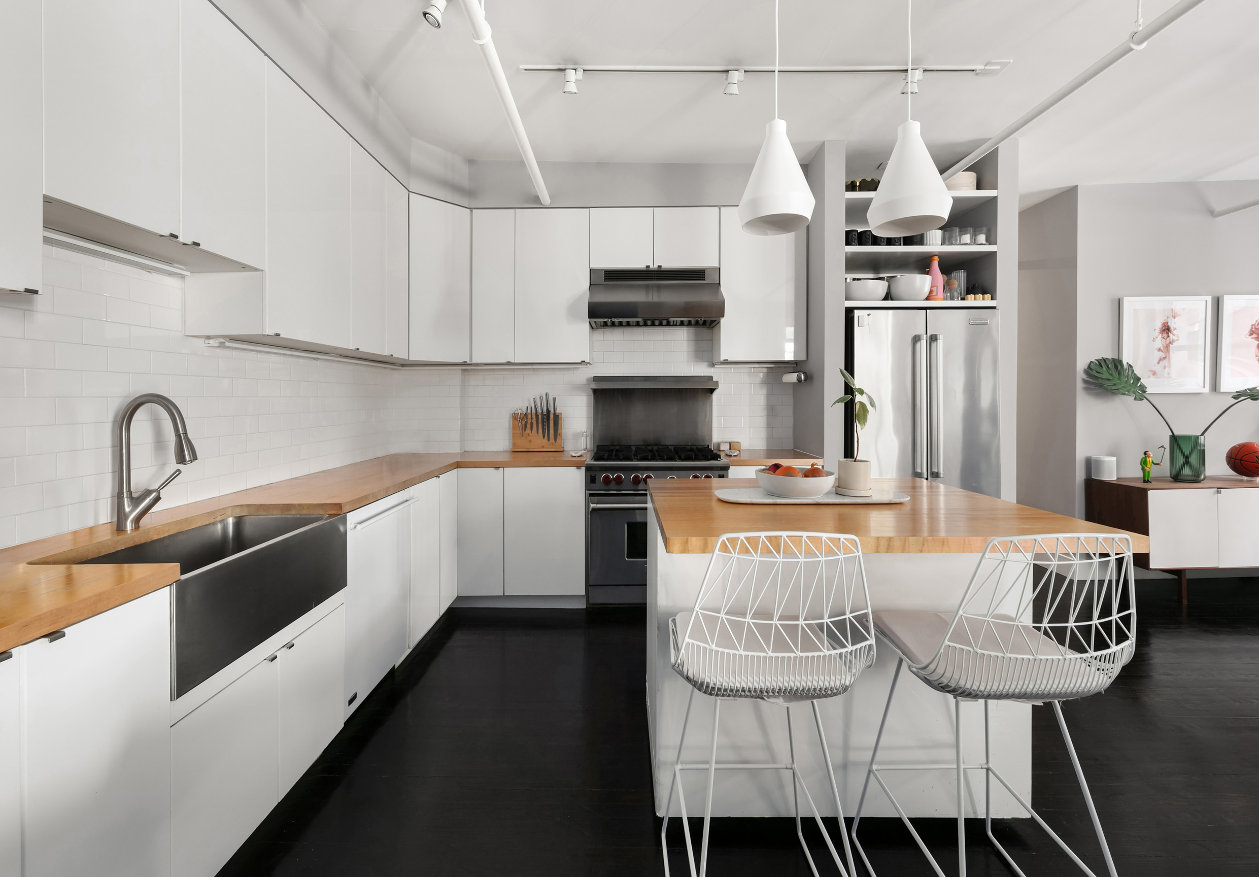 133-131 West 28th Street, Unit 6C Manhattan, NY 10001 - Photo 4 of 10 a kitchen with granite countertop a sink appliances and cabinets