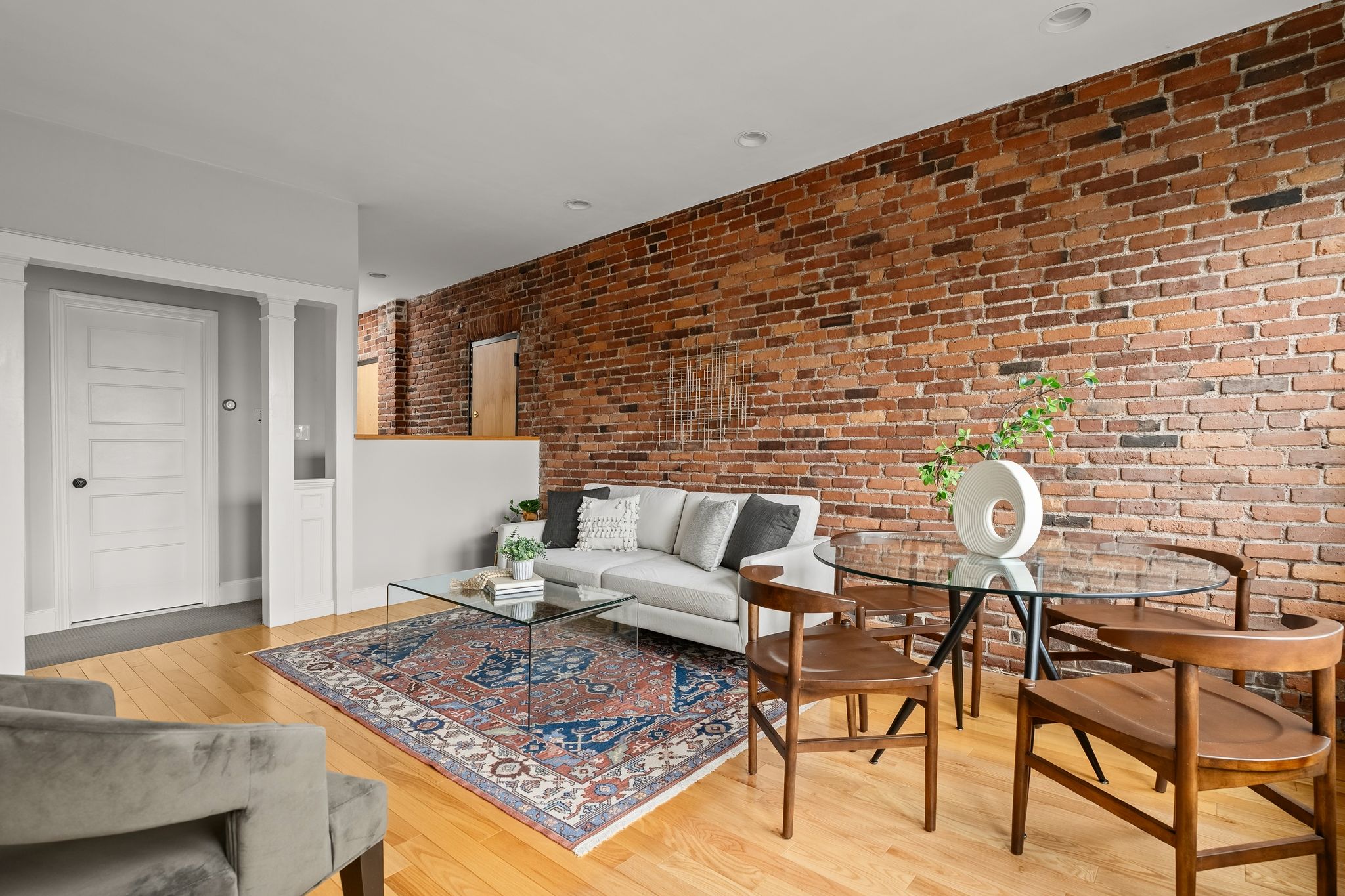 88 Hancock Street, Unit 17 Cambridge, MA 02139 - Photo 2 of 18 a living room with furniture and wooden floor