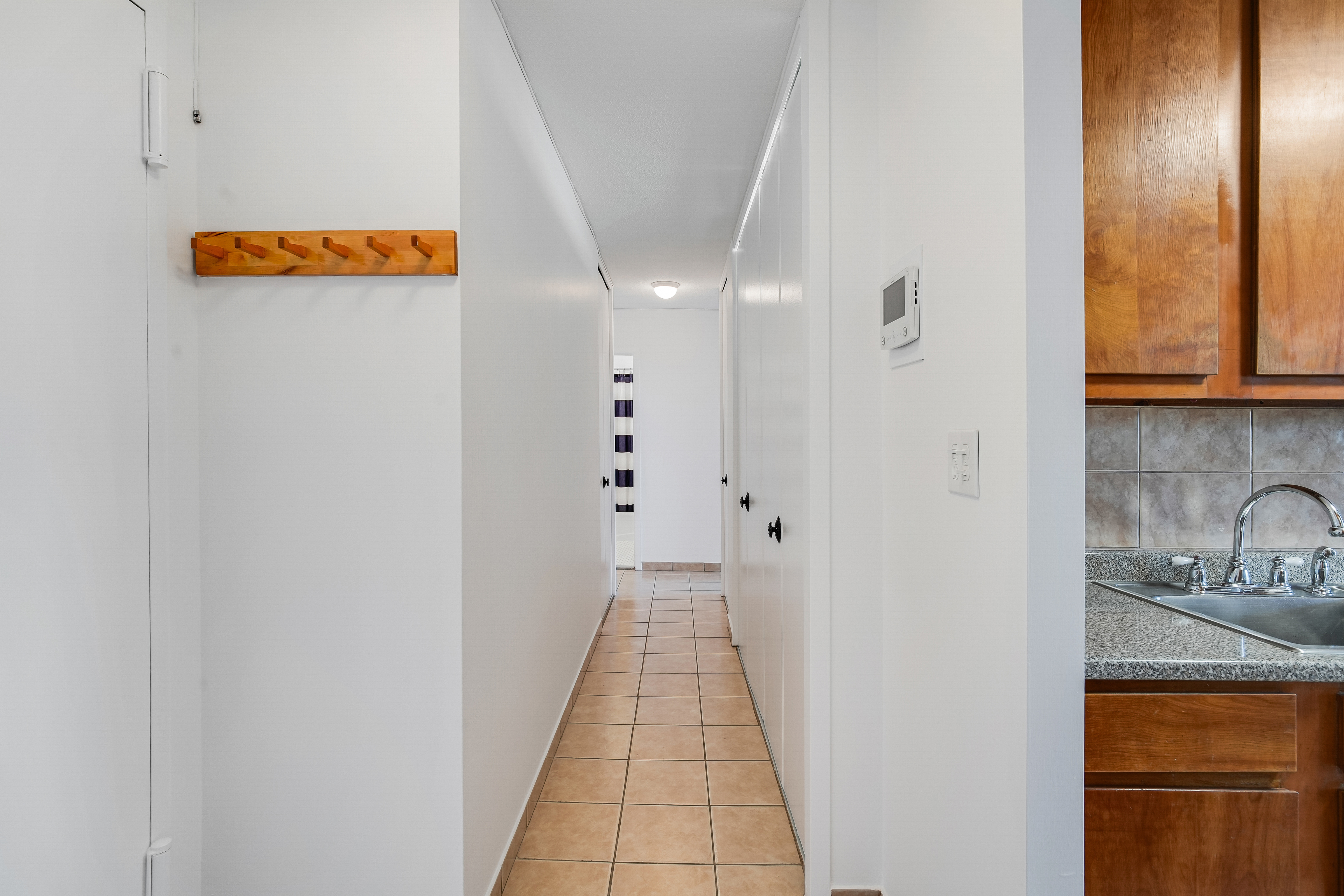 290 West 232nd Street, Unit 18B Bronx, NY 10463 - Photo 7 of 16 a hallway with sliding door and wooden floor