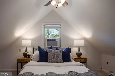 a bed room with a bed and a lamp