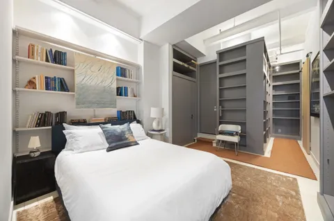 a bedroom with a bed and a cabinets