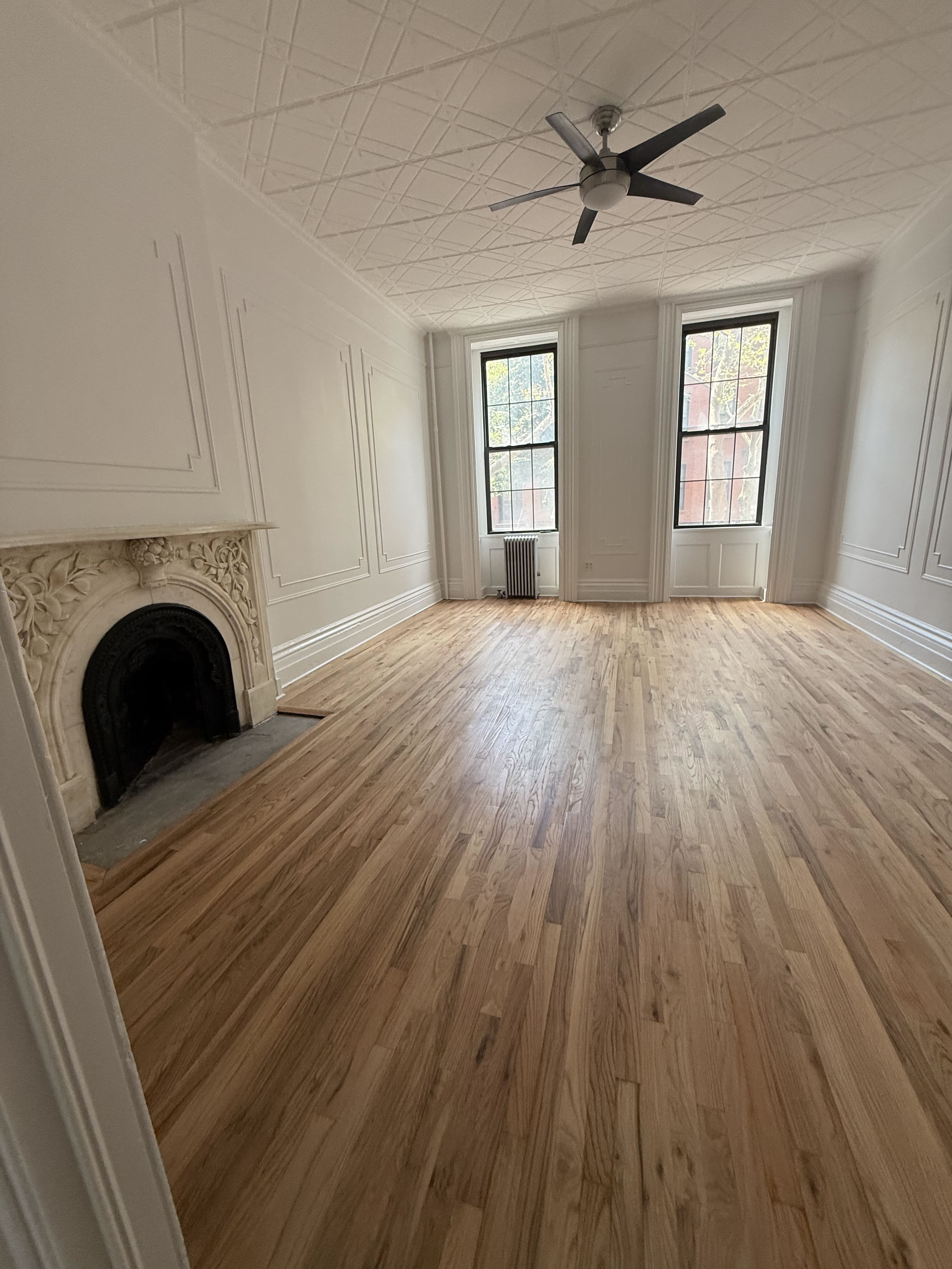 141 Summit Street, Unit 2 Brooklyn, NY 11231 - Photo 7 of 12 a view of an empty room with a fireplace and a window