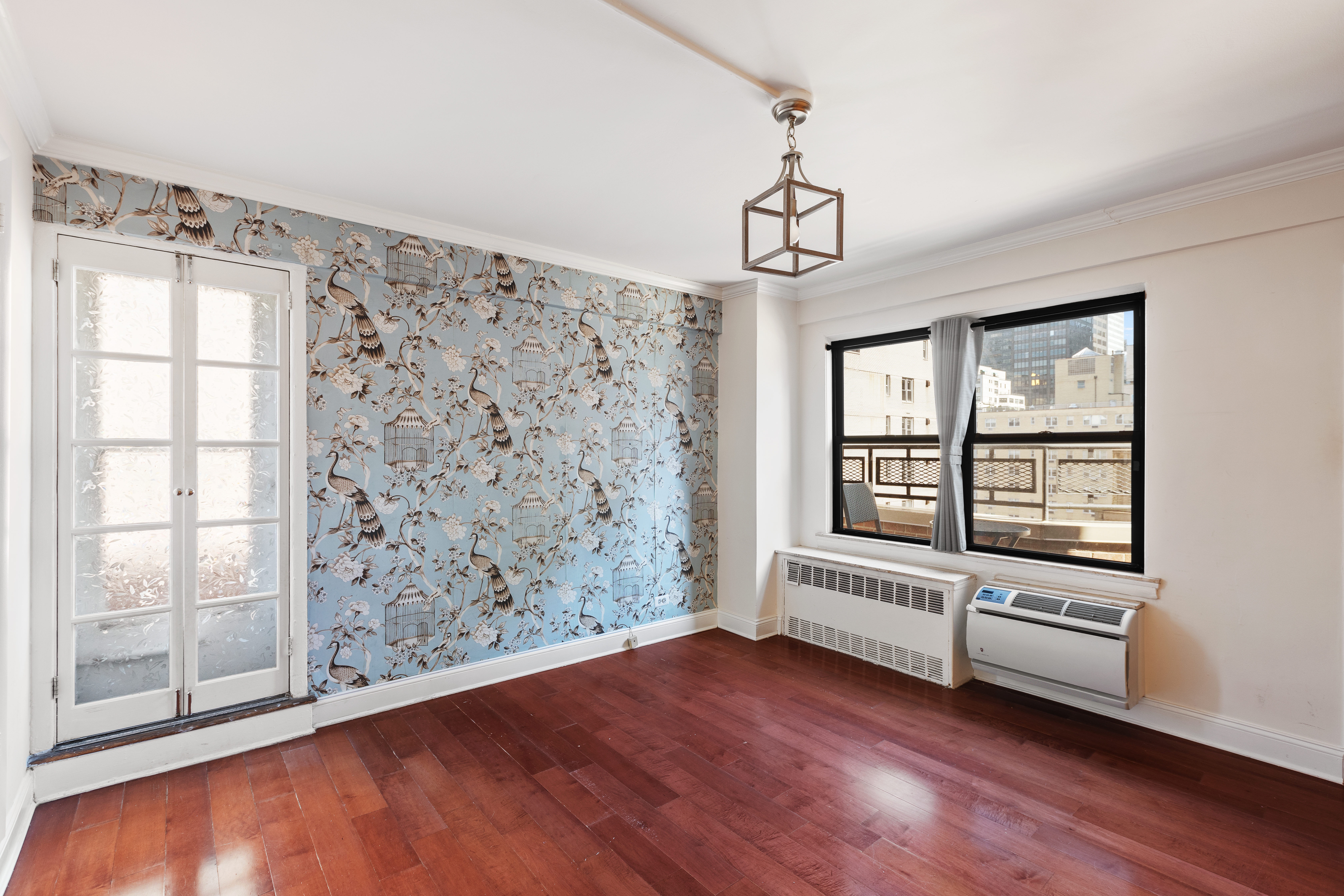 210 East 36th Street, Unit PHC Manhattan, NY 10016 - Photo 7 of 15 a view of a livingroom with wooden floor and a window