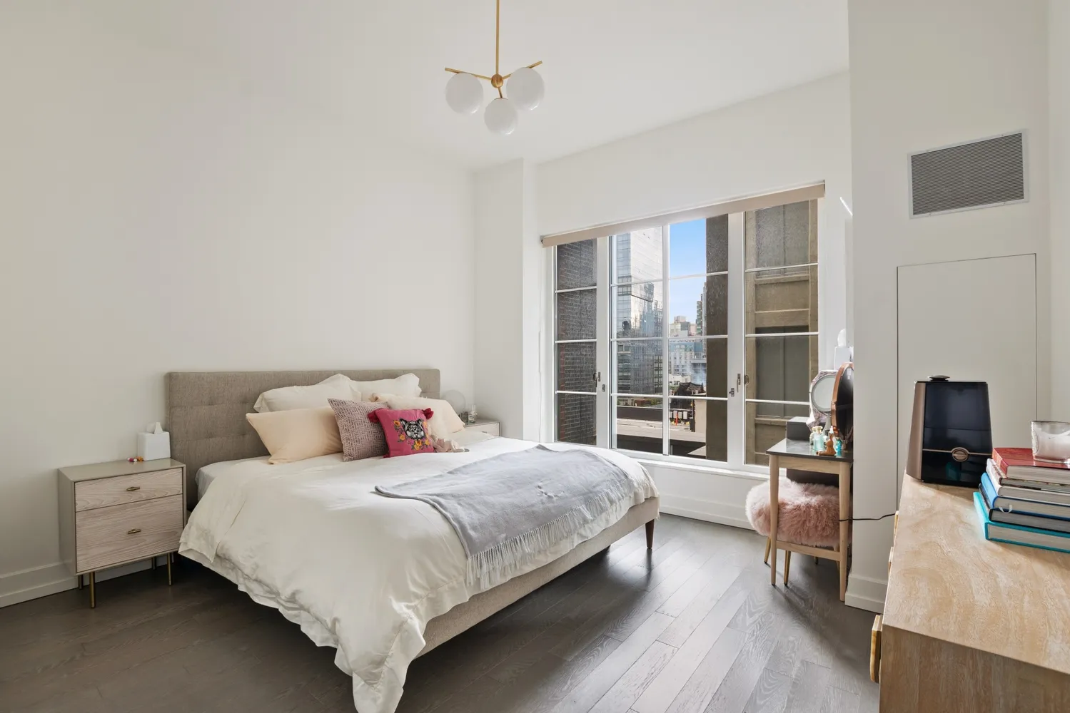 a bedroom with a bed and a wooden floor