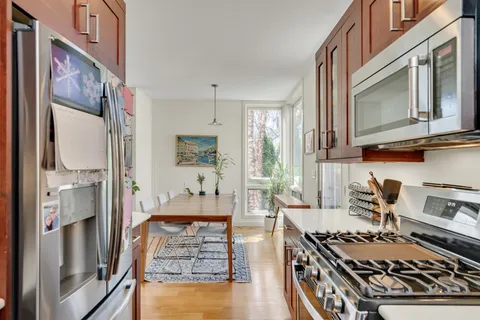 a kitchen with stainless steel appliances granite countertop a stove and a refrigerator