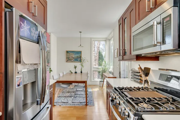 a kitchen with stainless steel appliances granite countertop a stove and a refrigerator