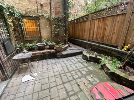 a view of a backyard with sitting area