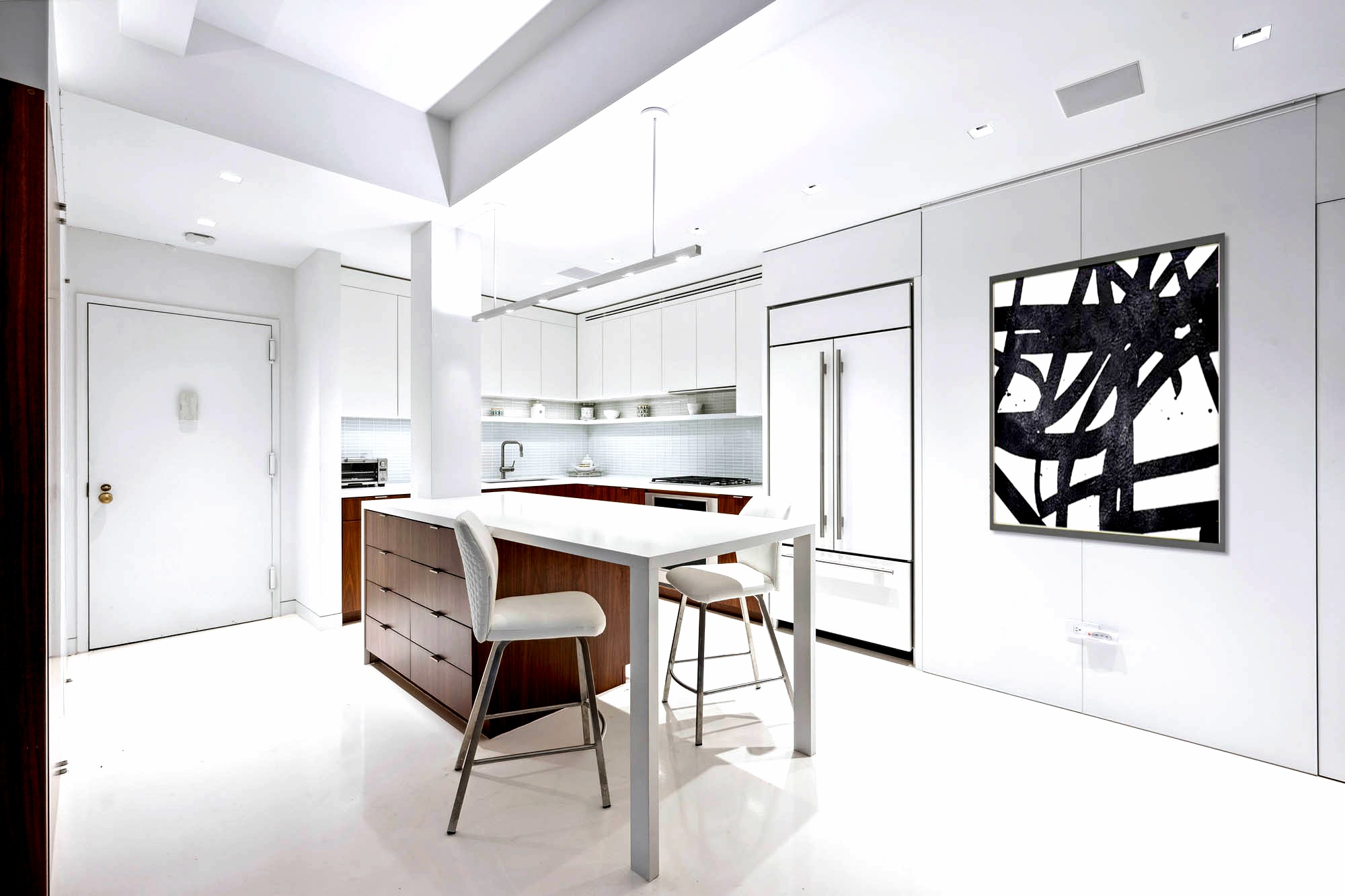 18 East 12th Street, Unit 4C Manhattan, NY 10003 - Photo 3 of 7 a kitchen with stainless steel appliances kitchen island granite countertop a refrigerator and microwave