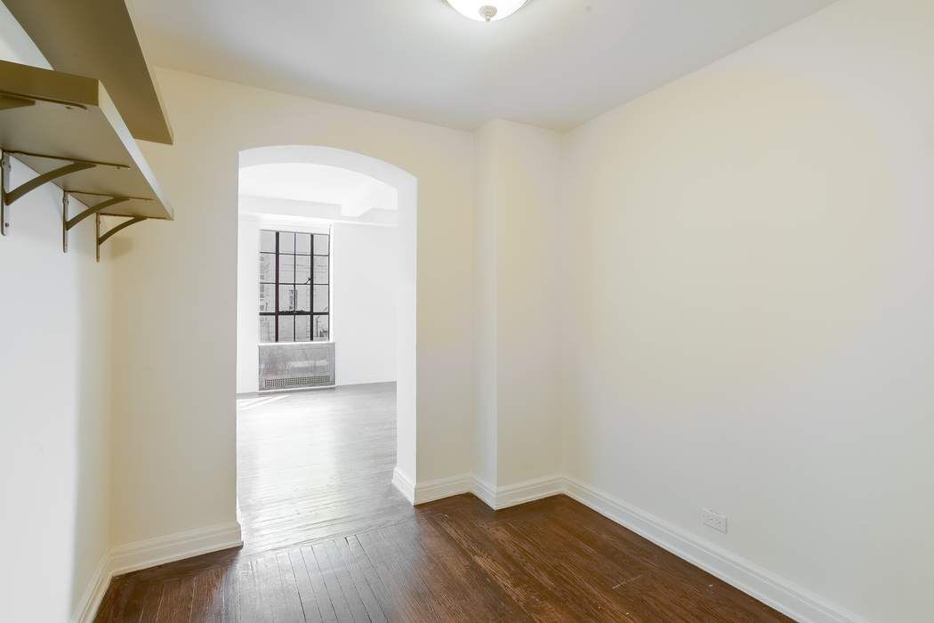 340 West 57th Street, Unit 14E Manhattan, NY 10019 - Photo 5 of 13 wooden floor in a empty room