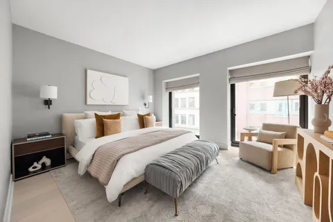 a spacious bedroom with a bed and a couch