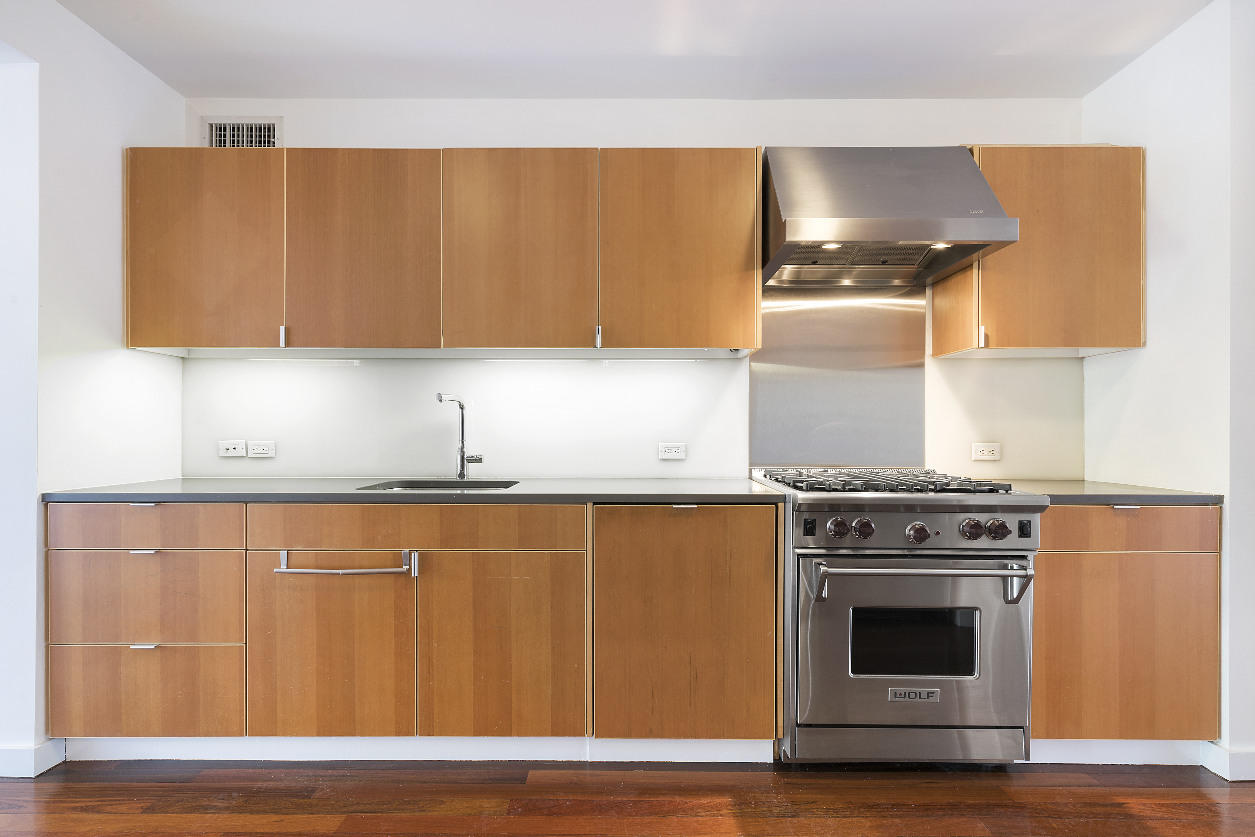 191 Luquer Street, Unit 3B Brooklyn, NY 11231 - Photo 3 of 7 a kitchen with granite countertop a stove and a wooden floors