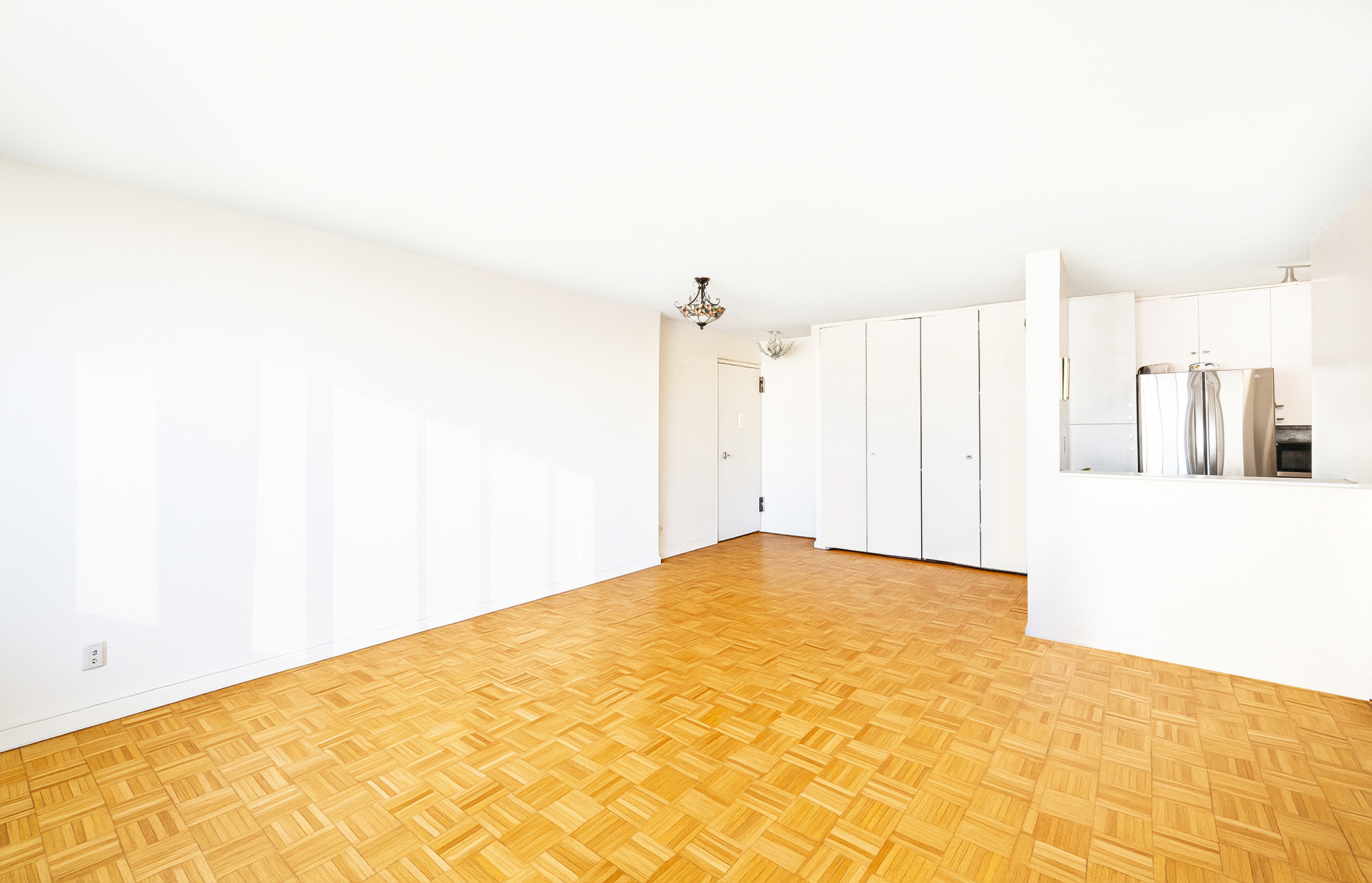 555 Main Street, Unit 1204 Manhattan, NY 10044 - Photo 6 of 15 a view of a white bed in a white room
