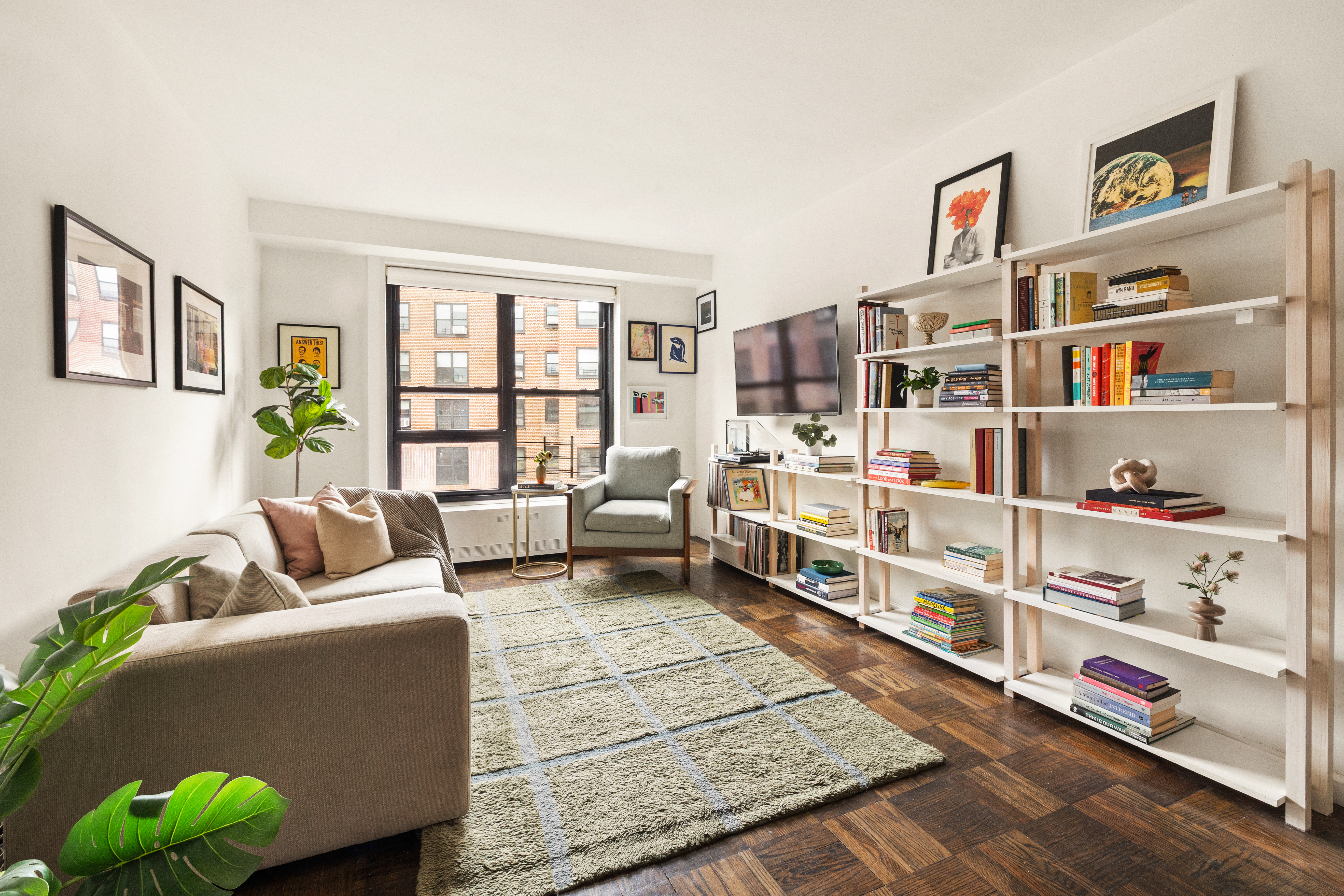 205 Clinton Avenue, Unit 12G Brooklyn, NY 11205 - Photo 3 of 8 a living room with furniture cabinets and a book shelf