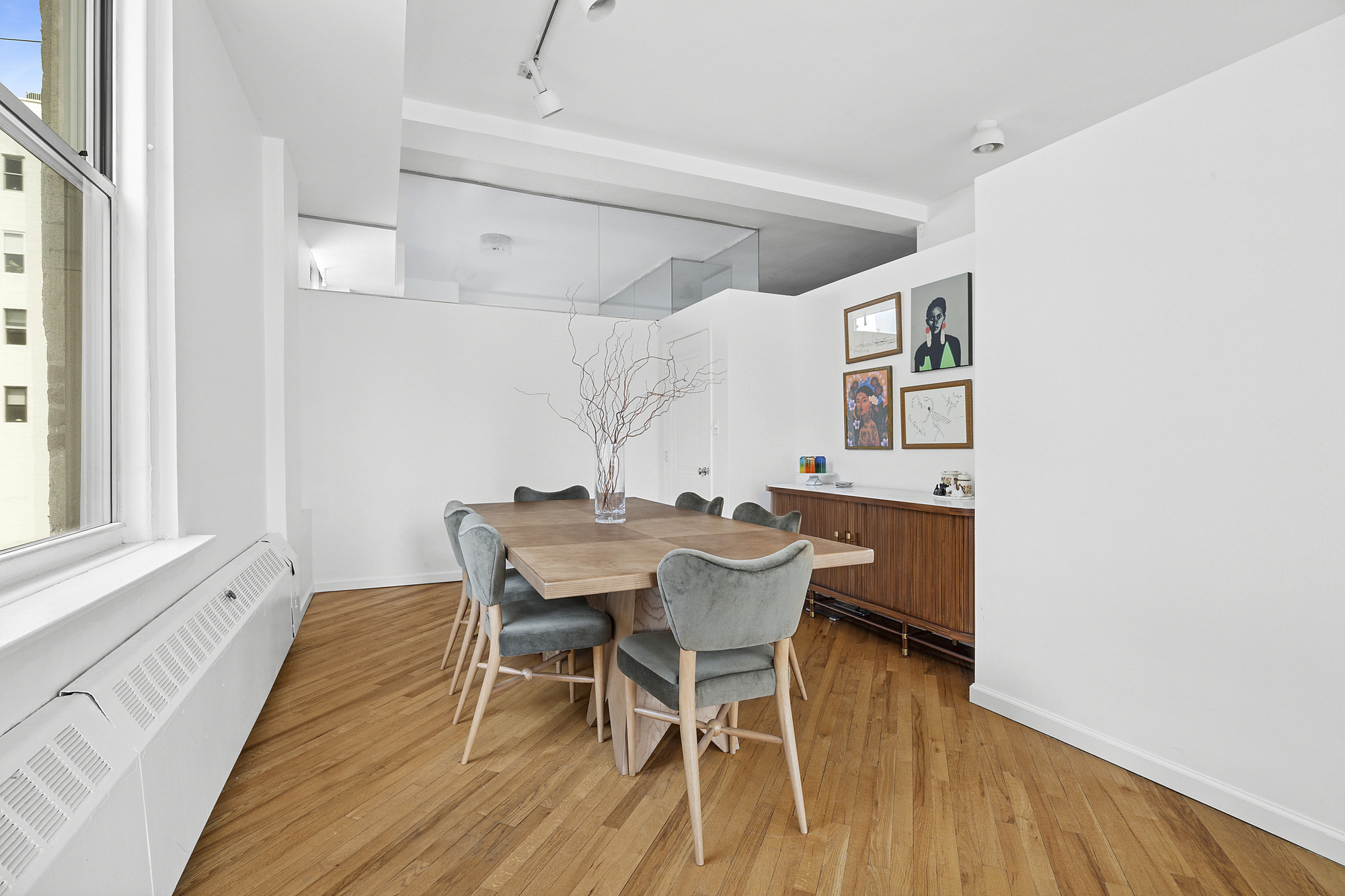 35 East 12th Street, Unit 8C Manhattan, NY 10003 - Photo 6 of 22 a dining room with furniture and wooden floor