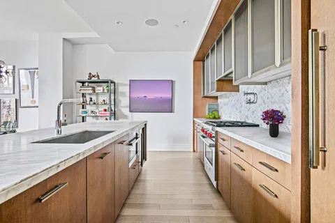 a kitchen with stainless steel appliances granite countertop a sink and stove