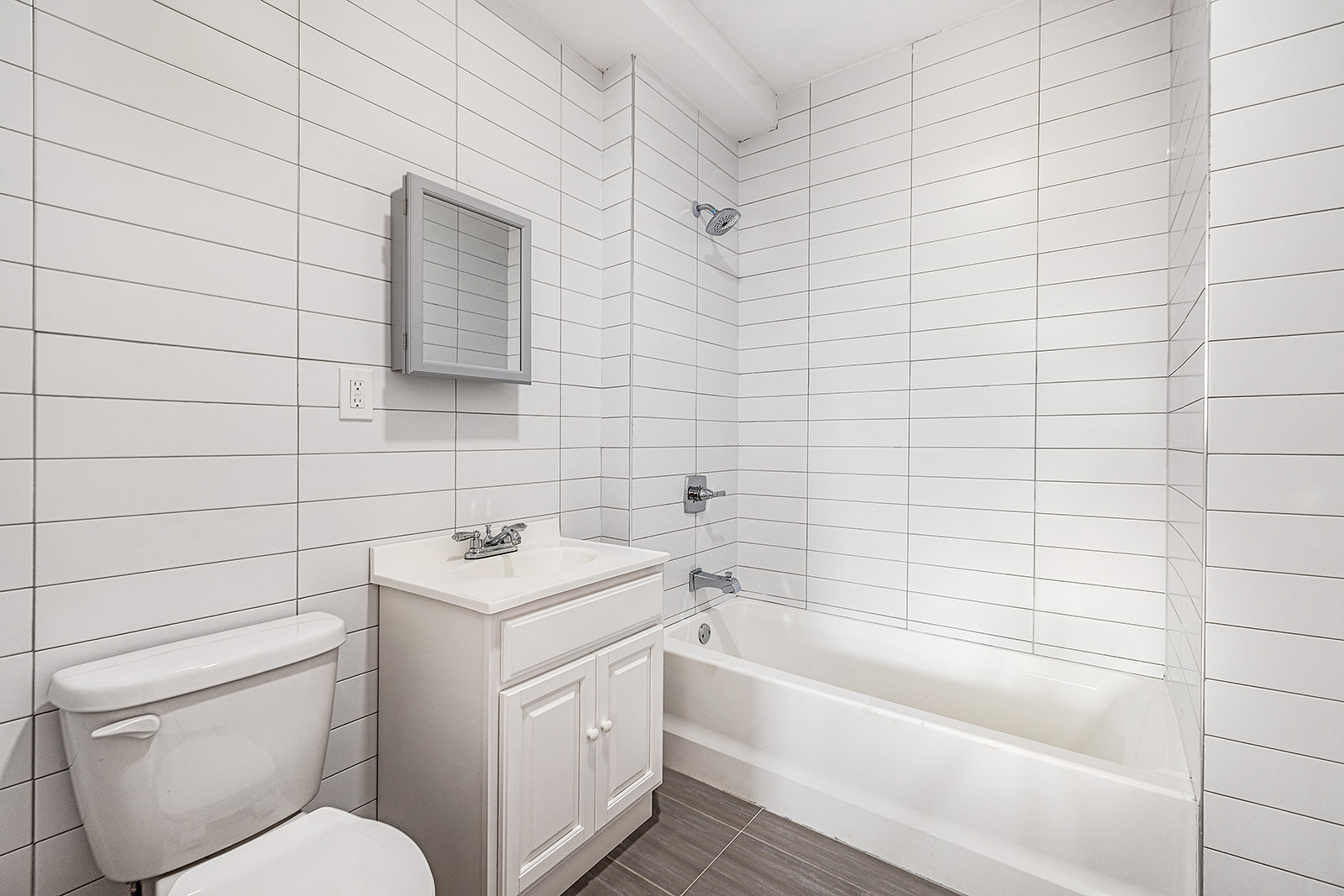 422 East 31st Street Brooklyn, NY 11226 - Photo 10 of 16 a bathroom with a sink toilet vanity and bathtub