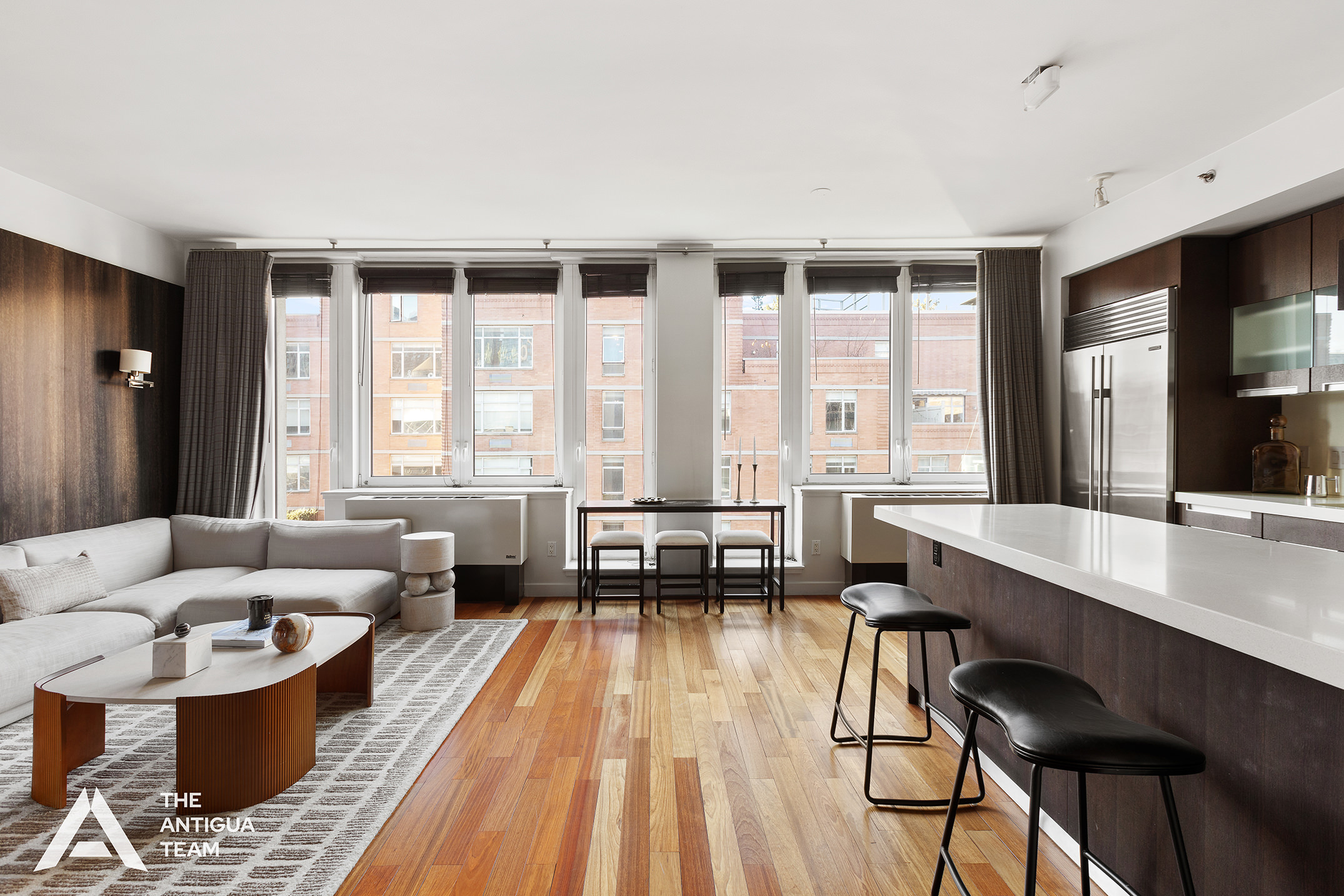 125 West 21st Street, Unit 12A Manhattan, NY 10011 - Photo 3 of 16 a living room with furniture and large windows