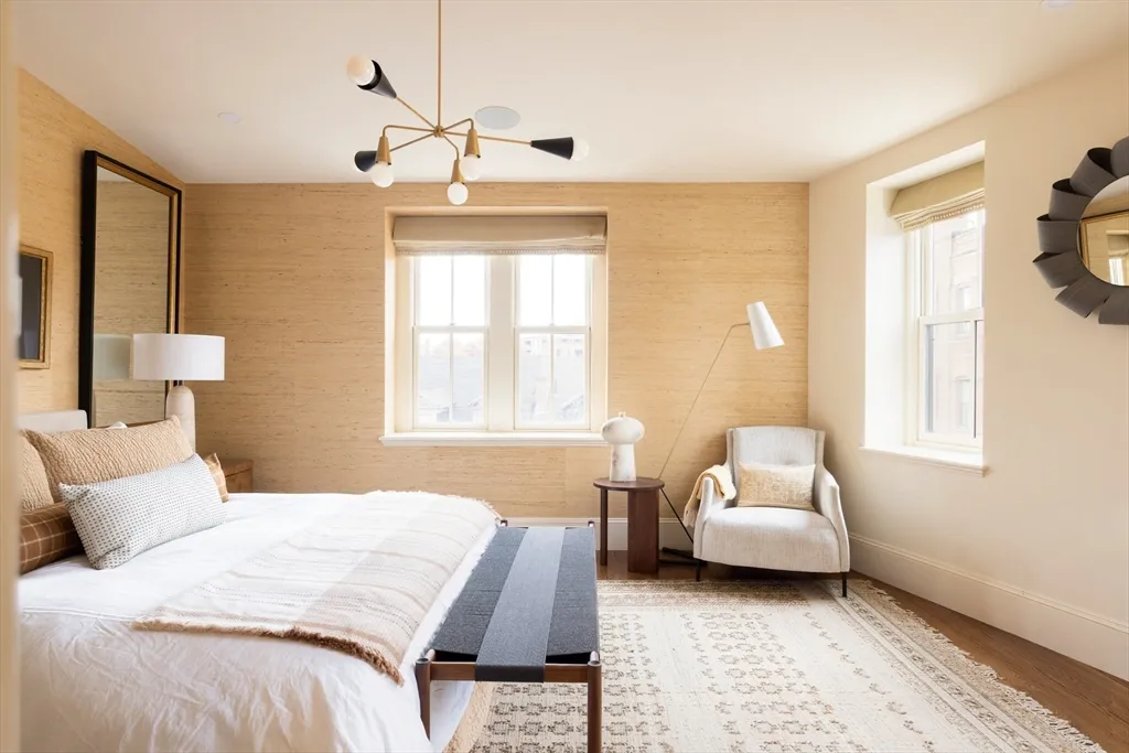 a bedroom with a bed couch and window